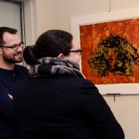 MGNE President, Daniel Embree, and Exhibitions Chair Becca Torres, look at a print by Rosetta Nesbitt.